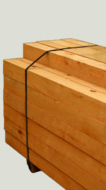 Stack of cypress posts tied together for delivery.