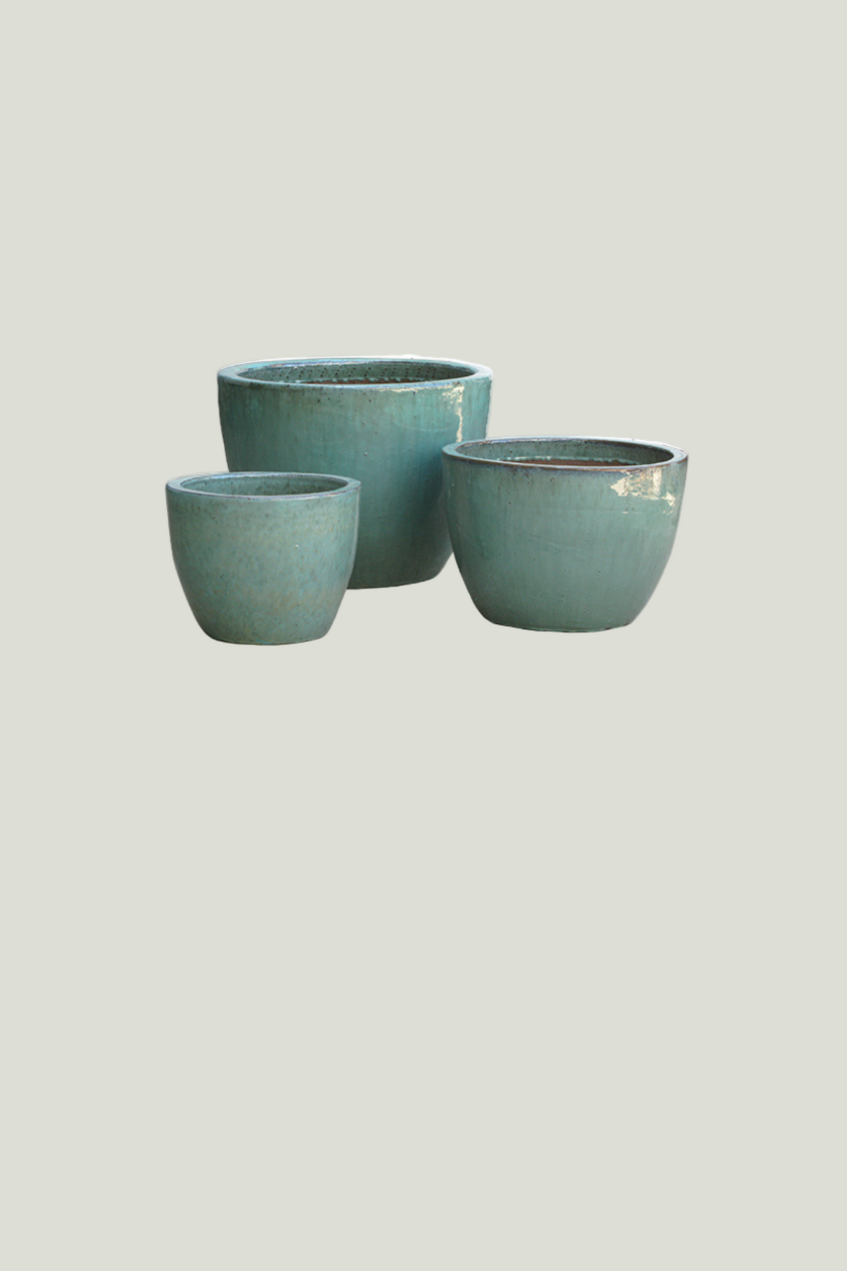 Three teal ceramic planters of different sizes