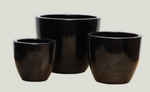 Three black ceramic pots of varying sizes