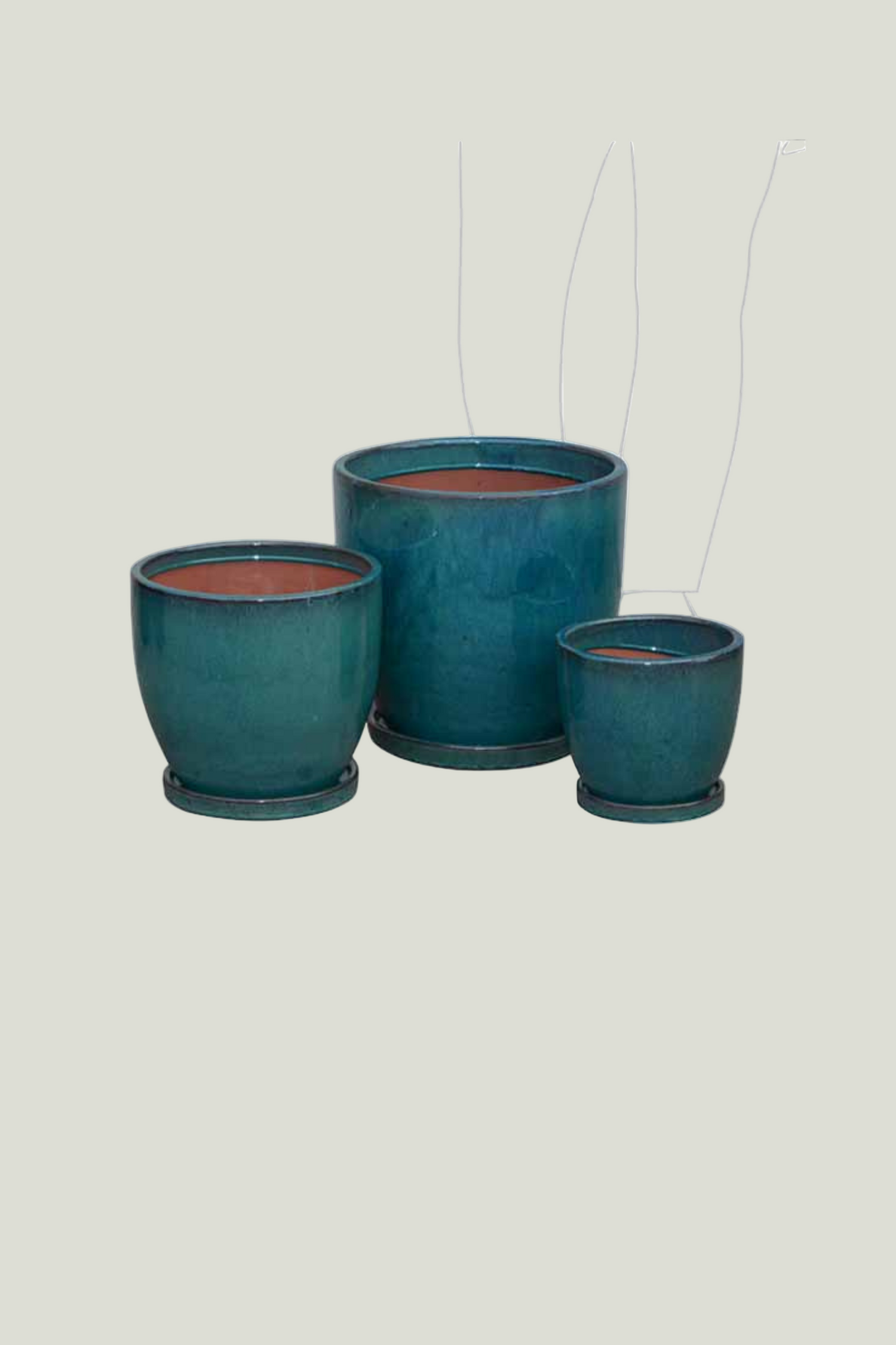 Three teal ceramic planters with a transparent background