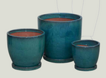Three teal ceramic planters with a transparent background