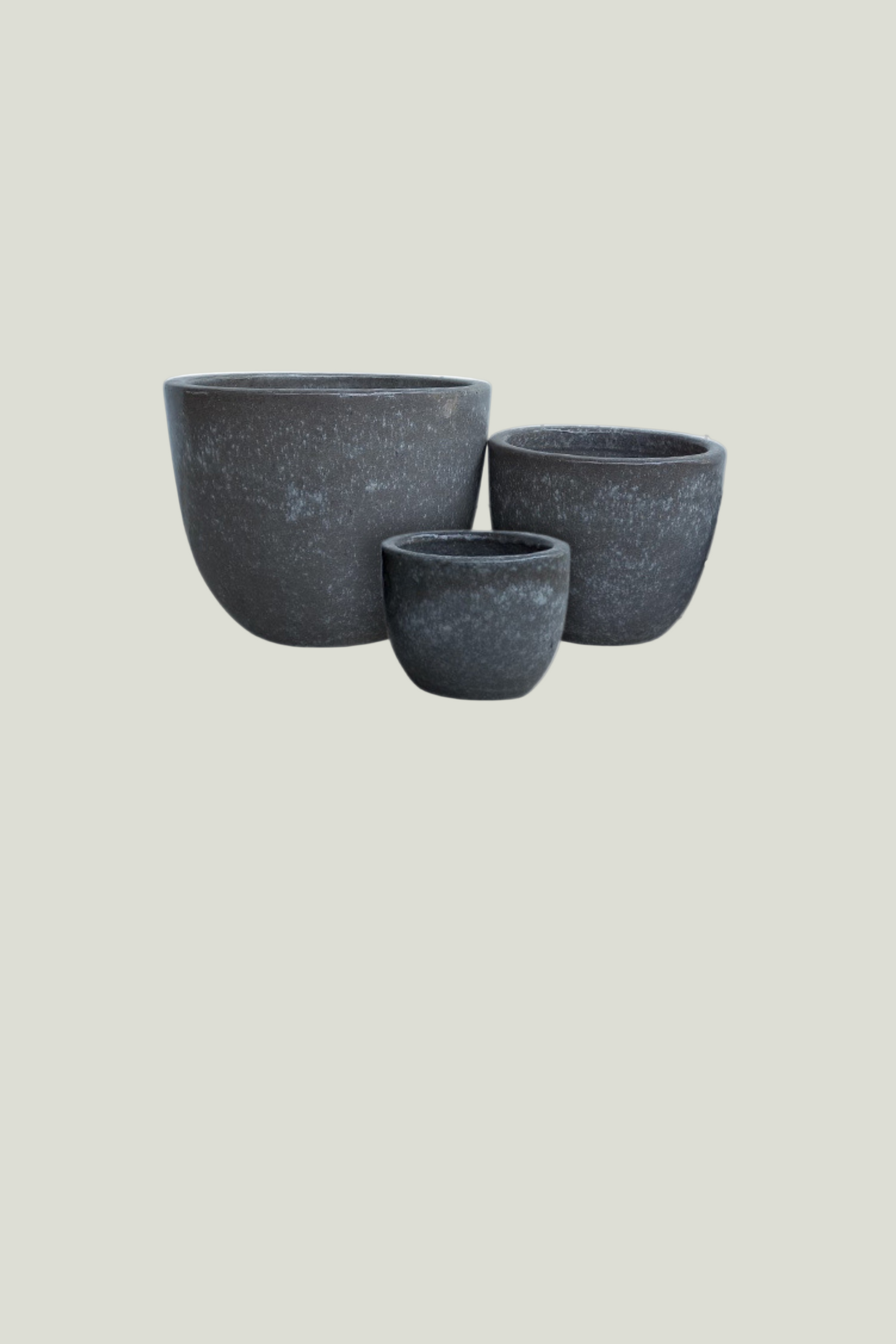 Three gray stone planters of different sizes