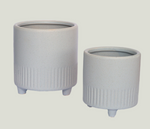 Two ribbed ceramic planters with feet
