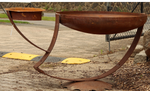 Rusted sculptural bird bath with two feeders