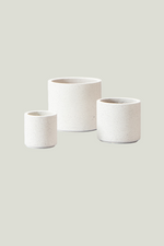 Three white ceramic planters of different sizes on a transparent background