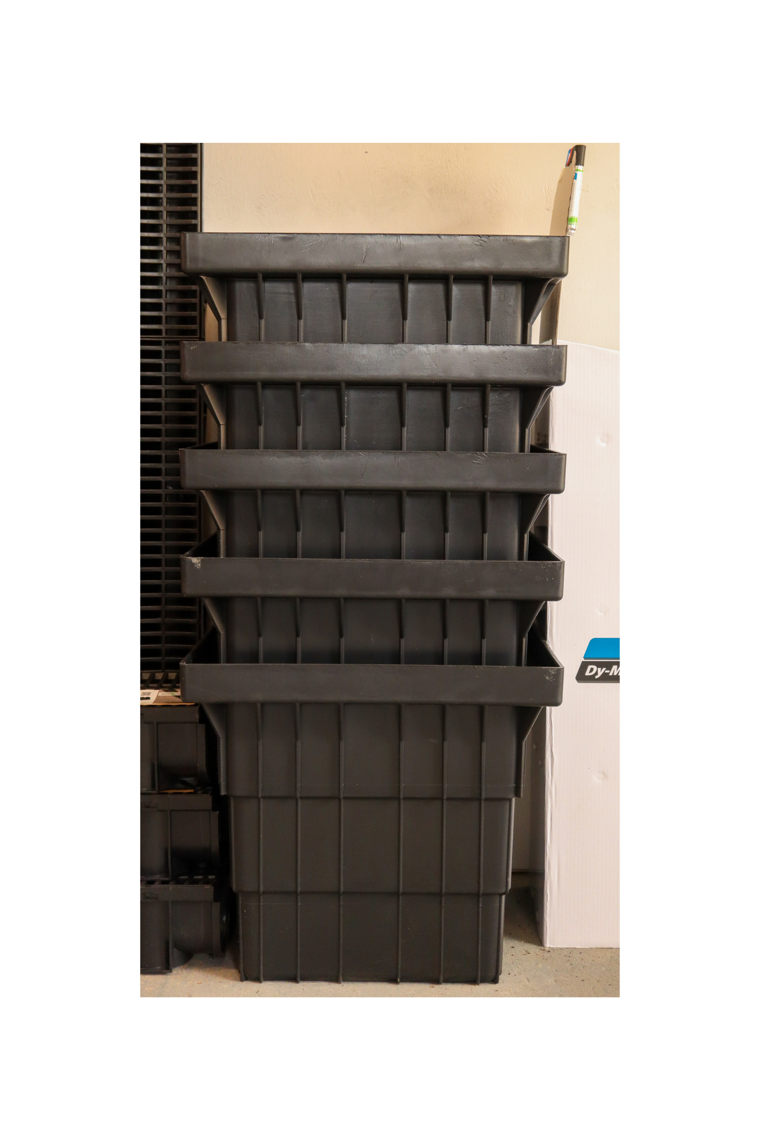 Stack of black plastic stormwater pits on a white background