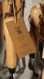 Wooden tool with a 'Ashwood' tag on a pegboard background
