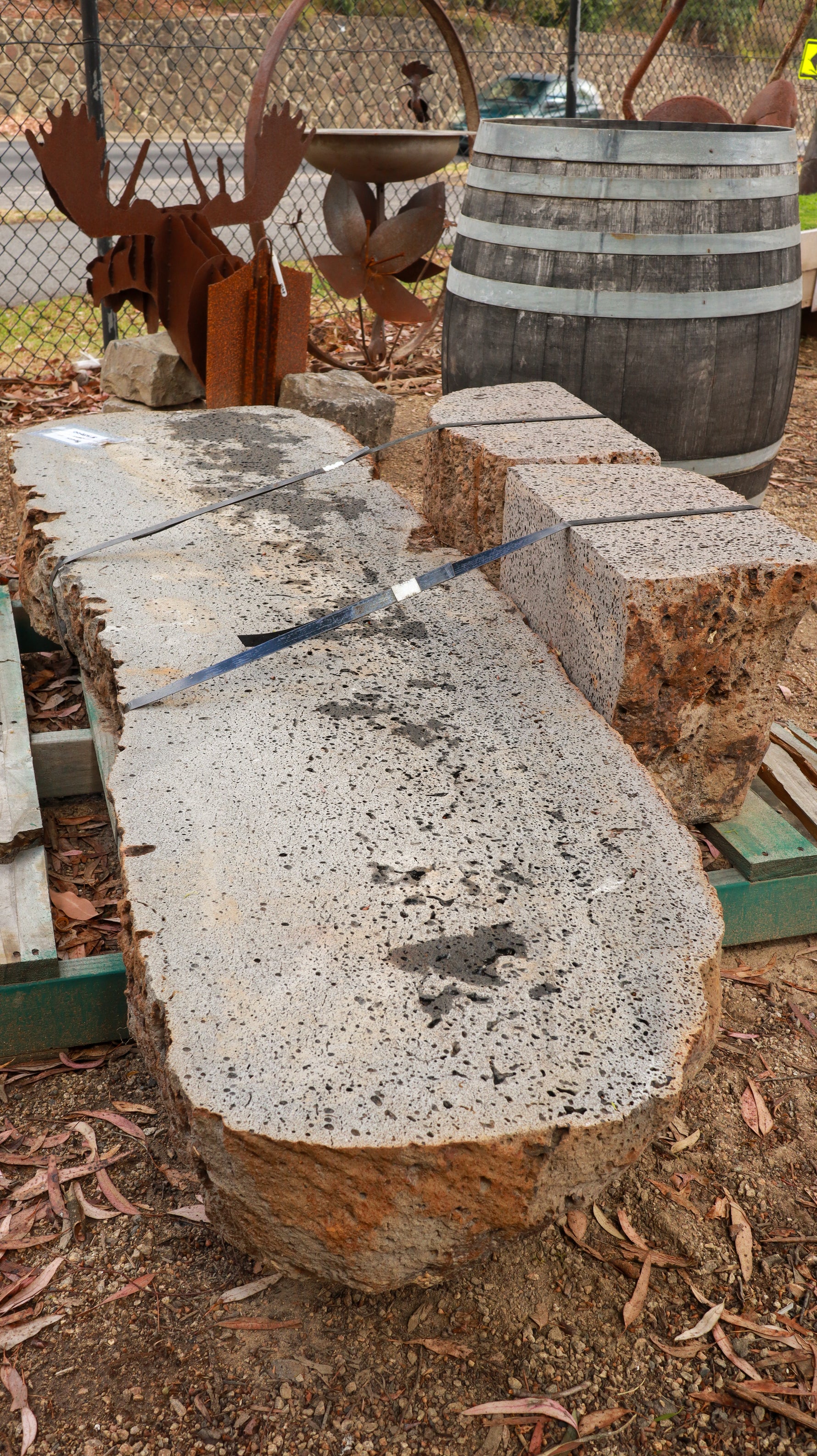 Large stone bench with a rustic appearance in an outdoor setting