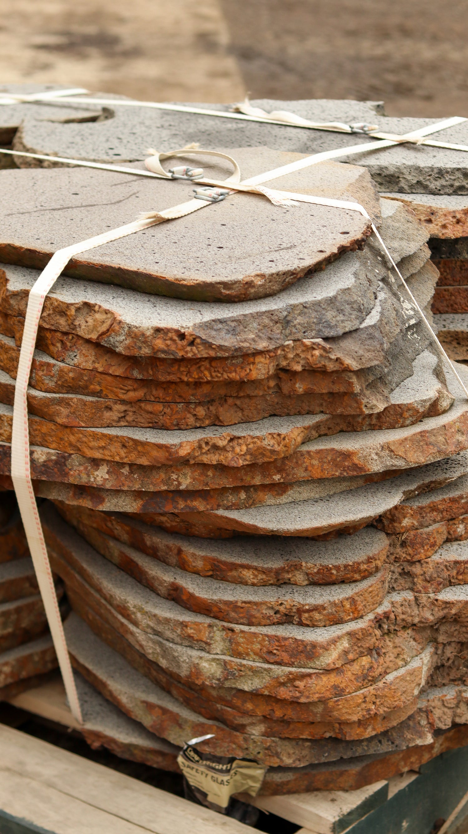 Stack of stone tiles tied together on a wooden pallet