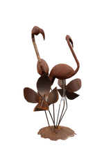 Rust-colored metal flamingo and flower sculpture 
