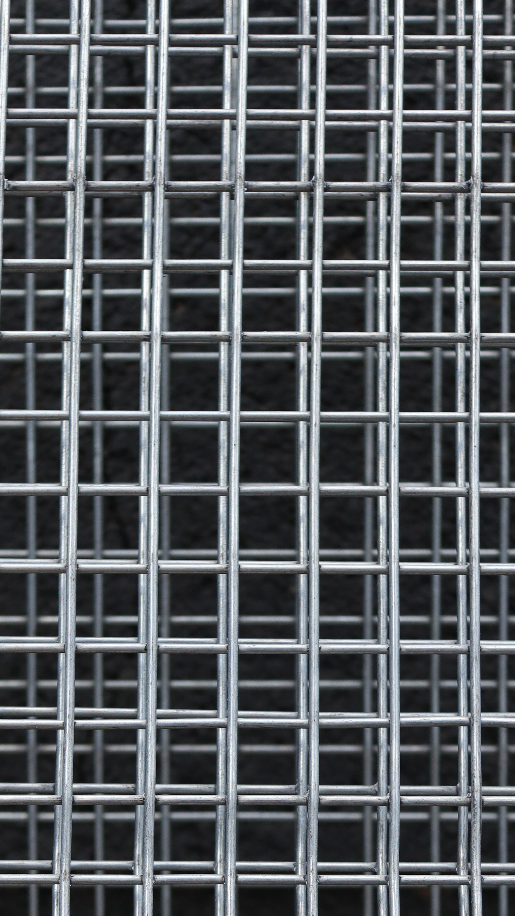 Metallic grid pattern on a black background