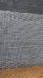 Metal mesh against a concrete wall