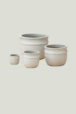 Set of four ceramic pots of varying sizes