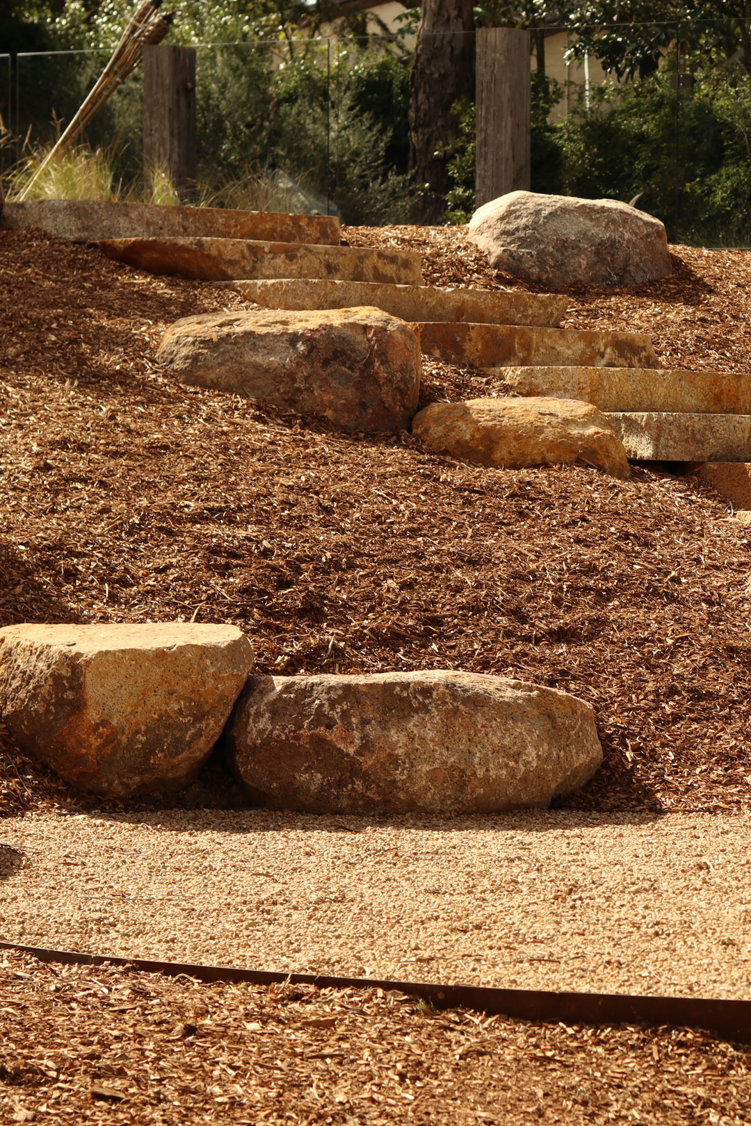 A natural style garden with large rocks and sawn steps