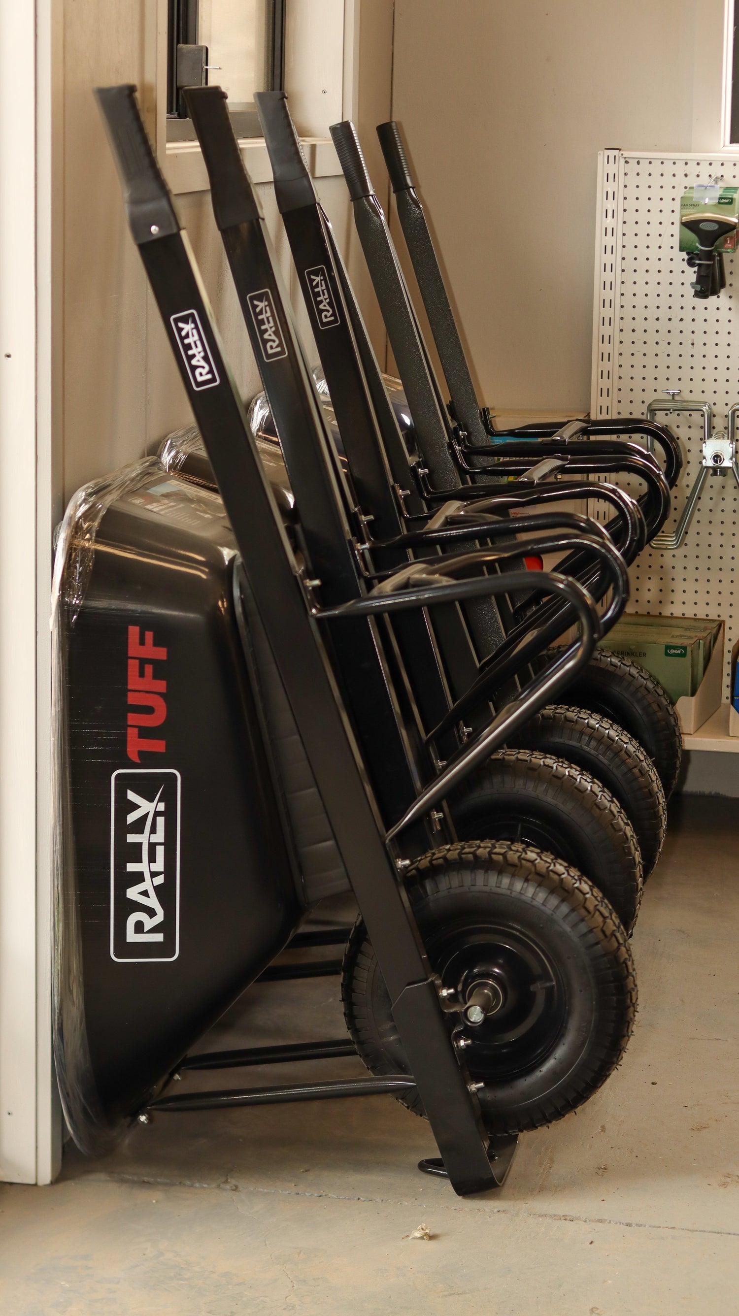 Row of black wheelbarrows lined up