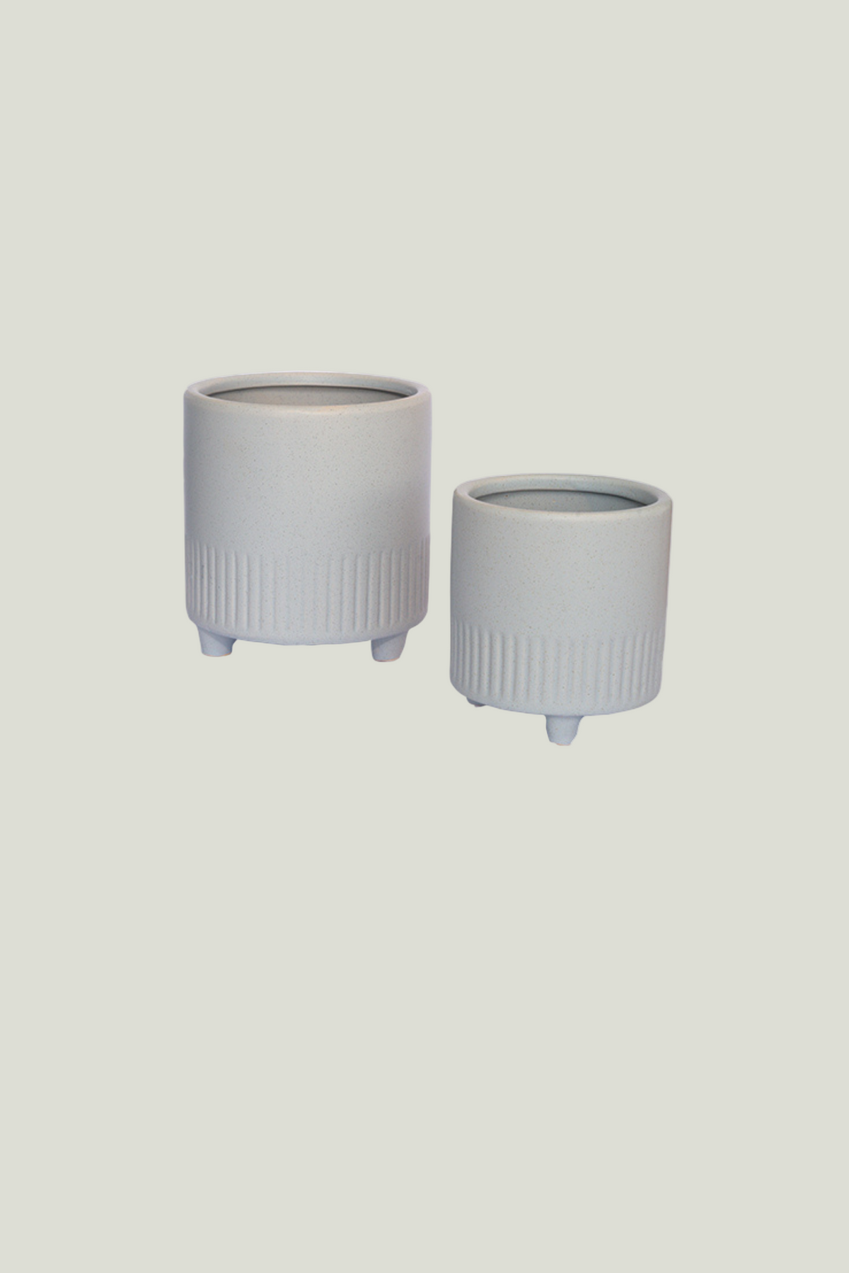 Two ribbed ceramic planters with feet