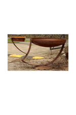 Rusted sculptural bird bath with two feeders