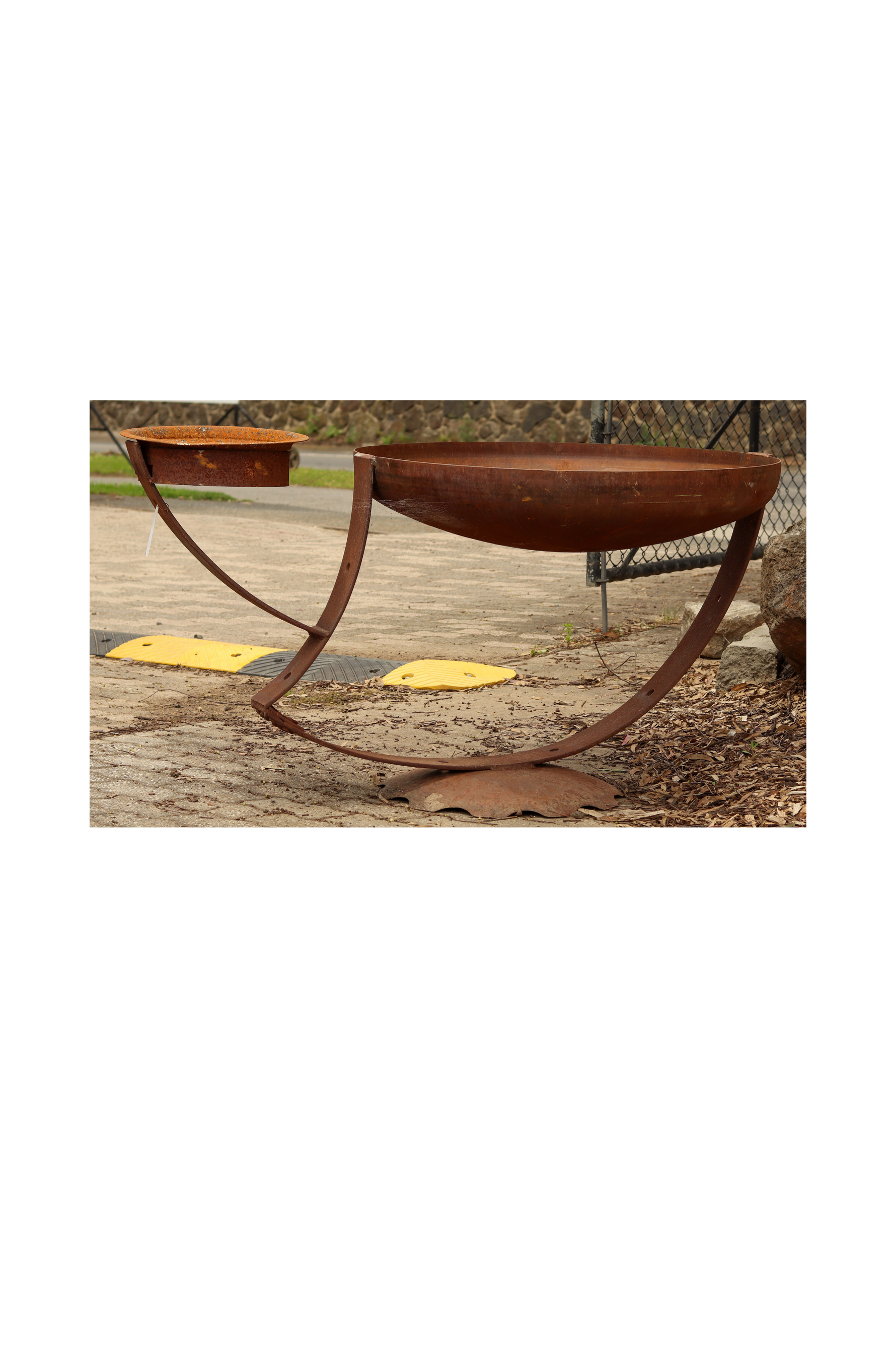 Rusted sculptural bird bath with two feeders