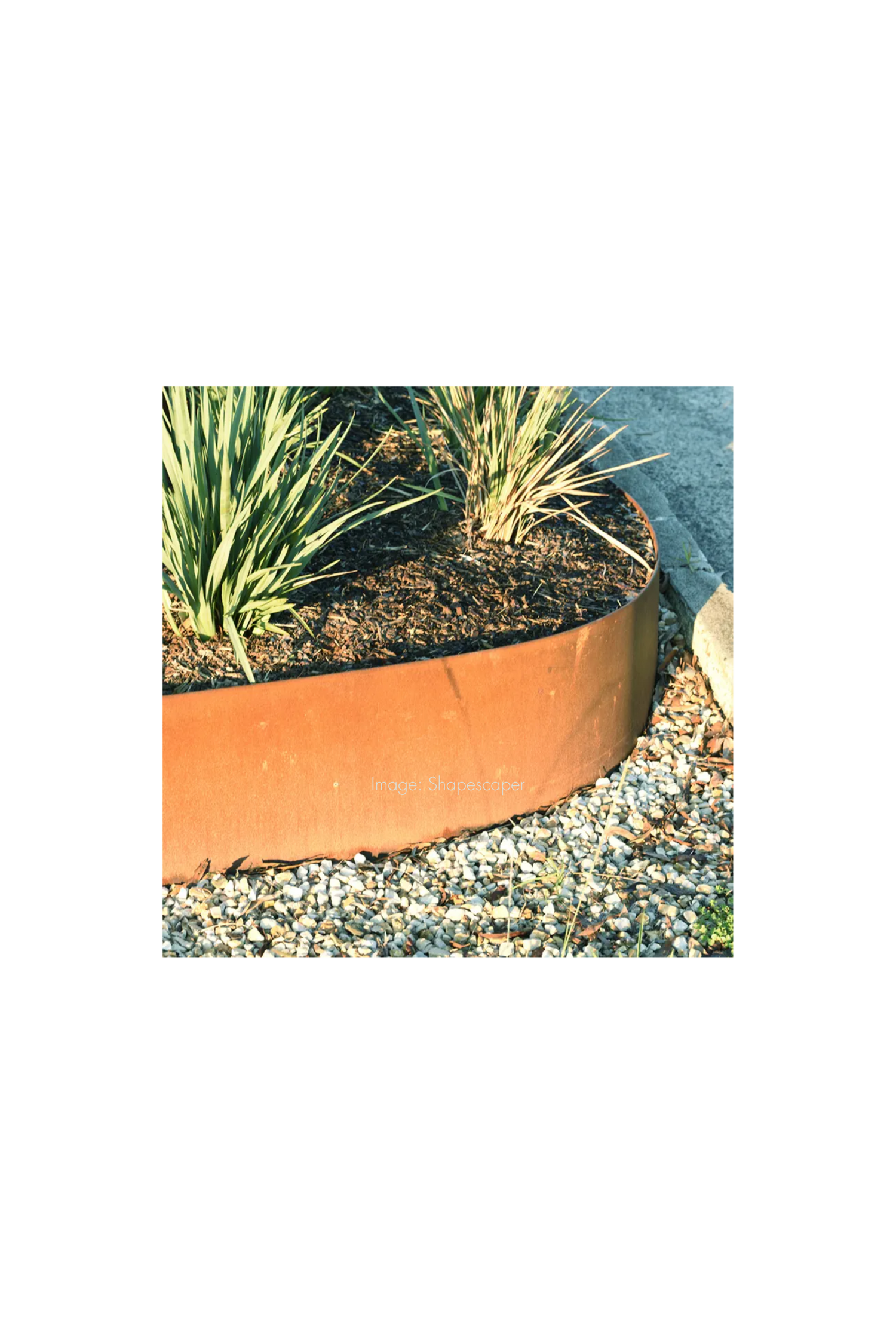 Round copper-colored metal planter with plants
