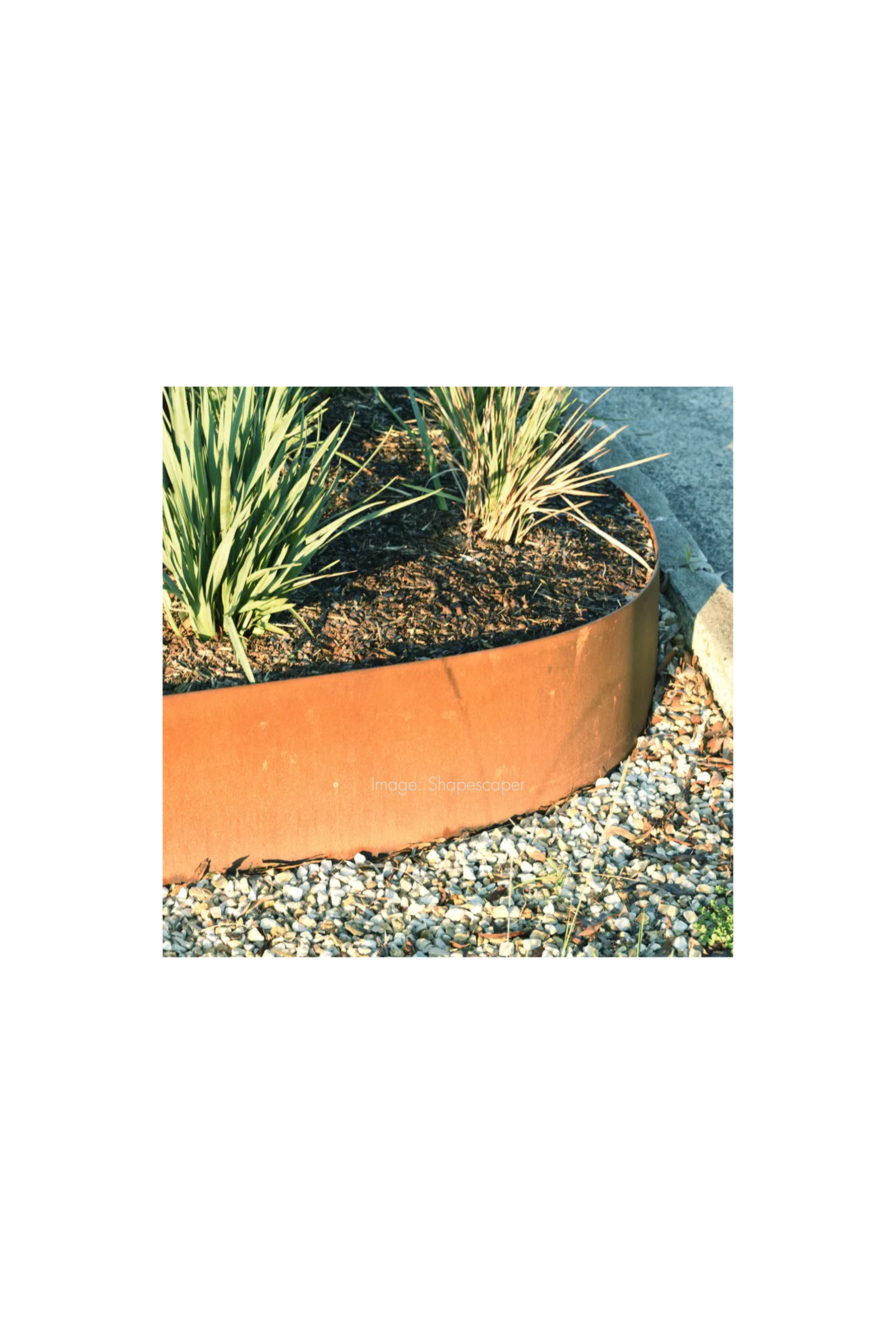 Round copper-colored metal planter with plants