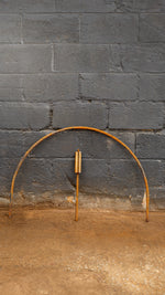 Steel arch hoop against dark blue brick background