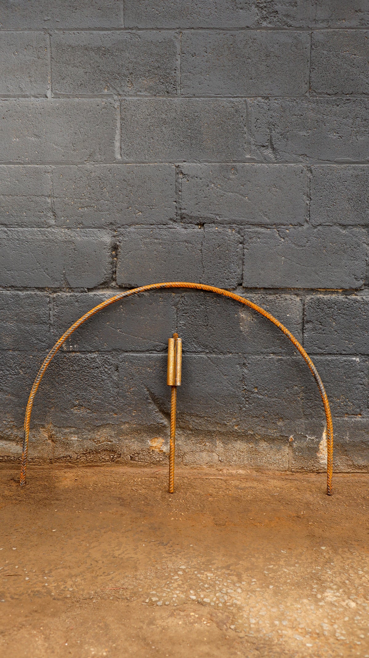 Steel arch hoop against dark blue brick background