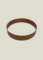 A weathered steel planter ring