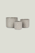 Three patterned ceramic pots of different sizes