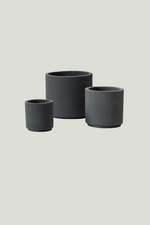 Three black ceramic planters of different sizes