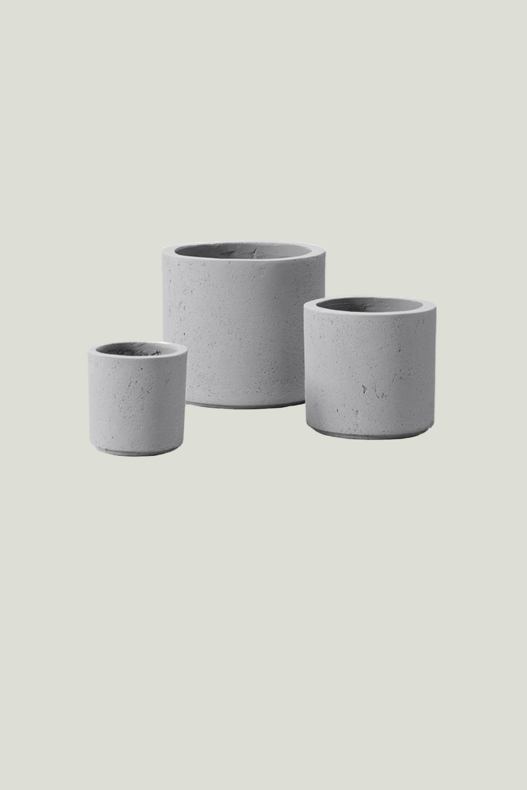 Three grey cylinder planters of different sizes