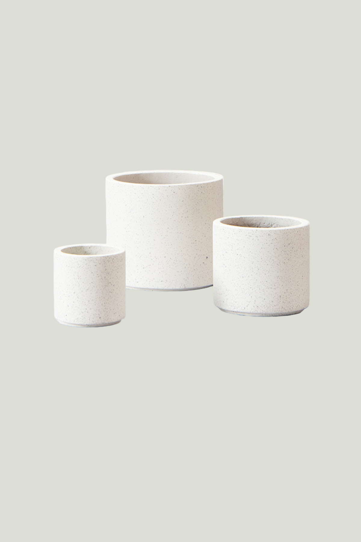 Three white ceramic planters of different sizes on a transparent background
